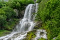 Beautiful waterfall surrounded by lush green vegetation Royalty Free Stock Photo