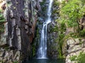 Beautiful waterfall of Veu da Noiva between the covered stones of moss and the vegetation