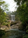 Beautiful waterfall water flow cascading over a mountain in a forest jungle wallpaper Royalty Free Stock Photo