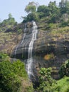 Beautiful waterfall water flow cascading over a mountain in a forest jungle wallpaper Royalty Free Stock Photo