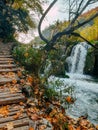 Beautiful waterfall and wooden stairs at famous Plitvice Lakes National Park in Croatia in autumn Royalty Free Stock Photo