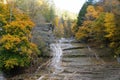 Beautiful waterfalls from above the hills with the background of fall foliage near Buttermilk Falls, Ithaca, New York