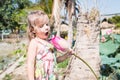 This beautiful waterlily or lotus flower. The girl hold in her hands a flower, sniff it and smile.