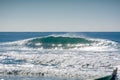 A wave breaks empty during mullet season at Campeche beach in Florianopolis Brazil