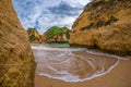 Beautiful wave in famous rock formation in a bay on the beach of Tres Irmaos in Alvor, PortimÃÂ£o, Algarve, Portugal, Europe. Royalty Free Stock Photo