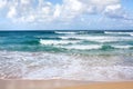 Beautiful waves on blue ocean with white foam blue sky with clouds background