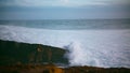 Beautiful waves crashing rocky shore. Foaming sea washing hitting wild coastline Royalty Free Stock Photo