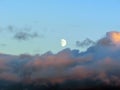 Background with rising moon above pink sunset clouds Royalty Free Stock Photo