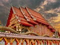 beautiful Way Buddhist temples in Phuket Thailand. Decorated in beautiful ornate colours of red and Gold and Blue. Lovely sunset