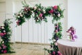 Wedding arch in the restaurant decorated with fresh pink and purple flowers Royalty Free Stock Photo