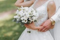 A beautiful wedding, a beautiful couple in love, laughing and kissing against the background of a green garden Royalty Free Stock Photo