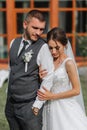 A beautiful wedding, a beautiful couple in love, laughing and kissing against the background of a green garden Royalty Free Stock Photo