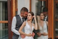 A beautiful wedding, a beautiful couple in love, laughing and kissing against the background of a green garden Royalty Free Stock Photo