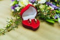 Beautiful wedding bouquet of blue roses and wedding rings of the bride and groom in a red box in the form of a heart Royalty Free Stock Photo