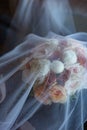 Beautiful wedding bouquet for bride in nude colors covered with veil Royalty Free Stock Photo