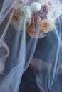 Beautiful wedding bouquet for bride and shoes in nude colors covered with veil Royalty Free Stock Photo