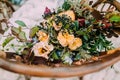 Beautiful wedding bouquet consisting of different flowers lying on an old brown chair Royalty Free Stock Photo