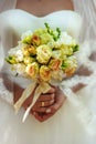 Beautiful wedding bouquet with creamy and yellow roses in bride`s hands in wedding day. Wedding decor. Idea for bridal bouquet. Royalty Free Stock Photo