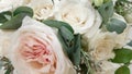 Beautiful wedding bouquet of delicate white pink cream roses. Silk petals and lush greens. A gift for the holiday Royalty Free Stock Photo