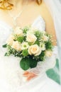 Beautiful wedding bouquet of flowers in hands of the bride at the ceremony of marriage family celebration Royalty Free Stock Photo