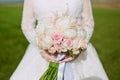 Beautiful wedding bouquet of flowers in hands of the bride