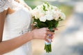 Beautiful wedding bouquet of flowers in hands of young bride Royalty Free Stock Photo