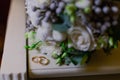 A beautiful wedding bouquet of golden rings of the newlyweds lie on the surface of the piano Royalty Free Stock Photo