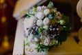 A beautiful wedding bouquet of golden rings of the newlyweds lie on the surface of a white piano. Wedding day Royalty Free Stock Photo