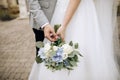 Beautiful wedding bouquet in the hands of the bride and groom Royalty Free Stock Photo