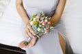Beautiful wedding bouquet in the hands of the bride of pink roses, white eustoma and eucalyptus branches Royalty Free Stock Photo