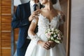 Beautiful wedding bouquet in hands of a young bride. Bridal bouquet of pink, white and peach rose flowers. Beauty