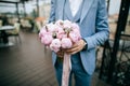 Beautiful Wedding bouquet of pink tulips in hands of groom Royalty Free Stock Photo