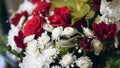 Beautiful wedding bouquet of red roses and white chrysanthemums