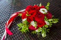Beautiful wedding bouquet of red on the table of the abstract structure. Wedding flowers