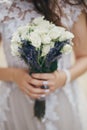 Beautiful wedding bouquet of roses and lavender in stylish bride hands on background of sunny street. Provence wedding. Bride Royalty Free Stock Photo