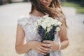 Beautiful wedding bouquet of roses and lavender in stylish bride hands on background of sunny street. Provence wedding. Bride Royalty Free Stock Photo