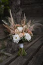 Beautiful wedding bouquet in vintage style. Boho bridal bouquet composed of lisianthus, pampas grass, roses and dried