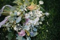 beautiful wedding bouquet of white flowers lies on the grass