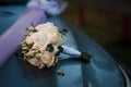 Beautiful wedding bouquet with white roses on a blue background. Bride's bouquet on a car Royalty Free Stock Photo