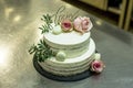 Beautiful wedding cake with cream With text Love on top pink flowers roses Royalty Free Stock Photo