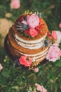 Beautiful wedding cake with flowers, outdoors. two levels