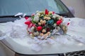 Decorated with flowers as for a wedding . Fresh flowers on the car. Beautiful colorfull wedding bouquet on white wedding car . Royalty Free Stock Photo