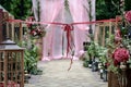 Beautiful wedding ceremony outdoors. Decorated chairs and wedding aisle with an awesome bow.. Rustic style. Royalty Free Stock Photo