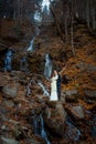 Beautiful wedding couple hugs on the waterfall, Autumn forest background Royalty Free Stock Photo