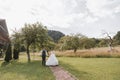 A beautiful wedding, a beautiful couple in love, laughing and kissing against the background of a green garden Royalty Free Stock Photo
