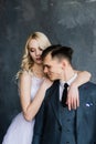 Beautiful wedding couple. Luxurious dress of the bride and stylish suit of the groom, studio photo shoot Royalty Free Stock Photo