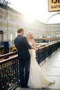 Beautiful wedding couple in Moscow, the bride and groom in a white dress in the interior, happy new family