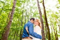 Beautiful wedding couple outside in green forest. Rear view. Royalty Free Stock Photo