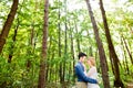 Beautiful wedding couple outside in green forest. Royalty Free Stock Photo