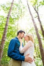 Beautiful wedding couple outside in green forest. Royalty Free Stock Photo